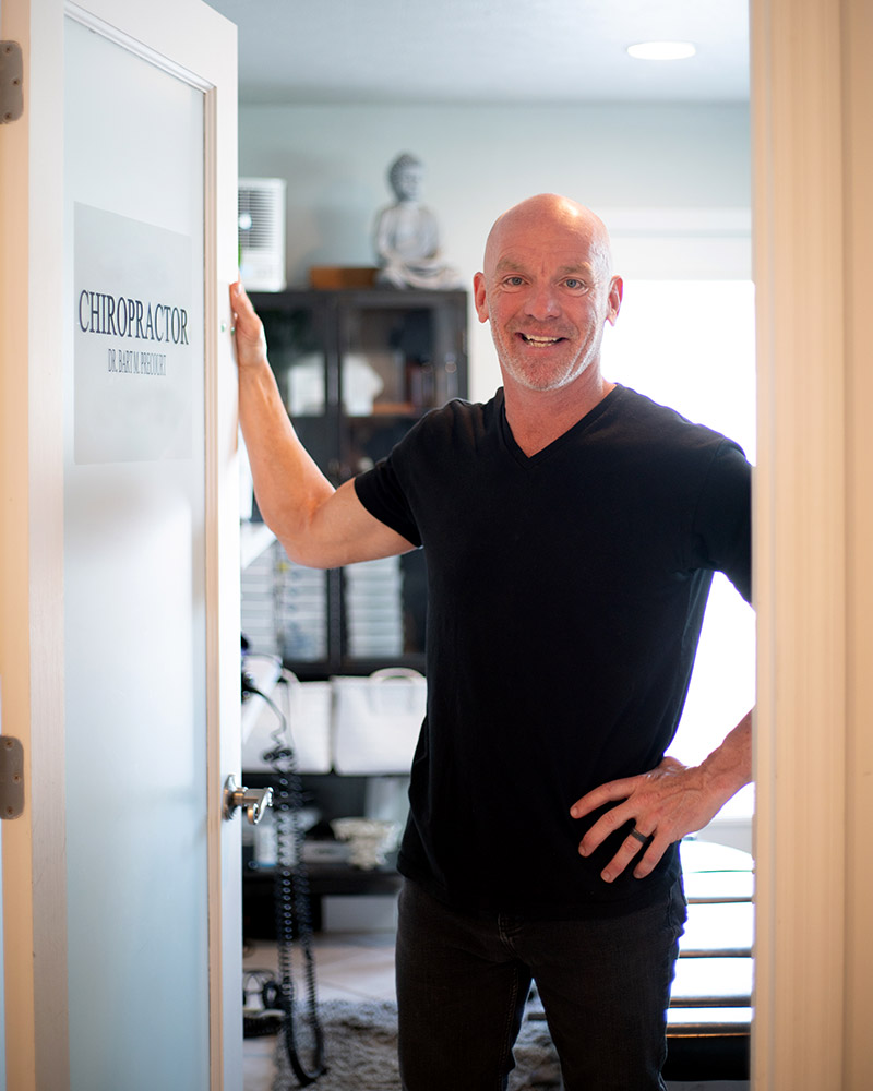 Dr. Bart Precourt standing in the doorway of his chiropractic office at Balance Health Studio on 30A in Seagrove Beach Florida