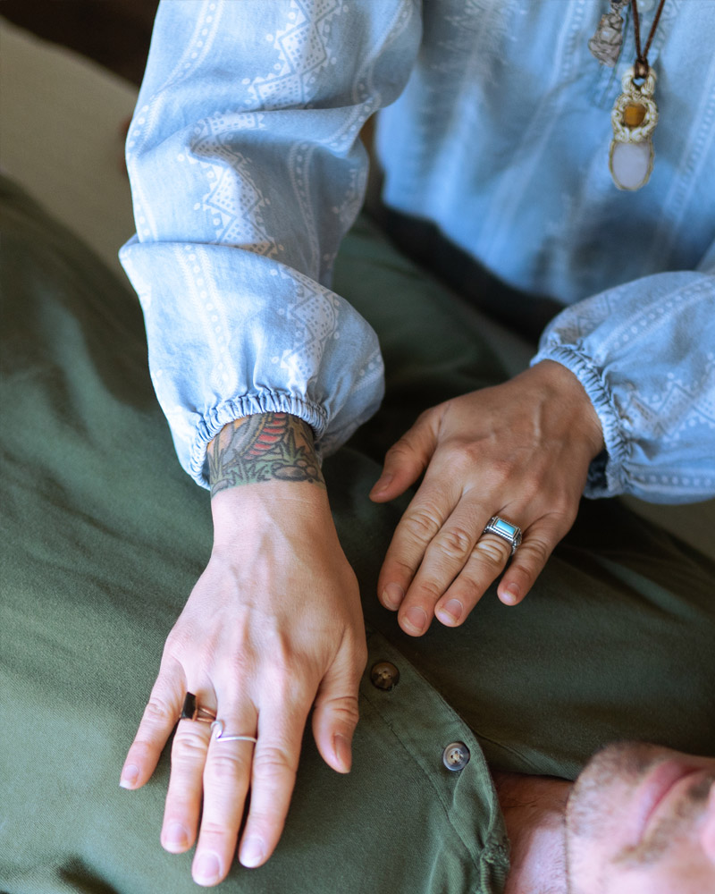 Gentle laying of hands during a private Reiki session at Balance Health Studio in Seagrove Beach